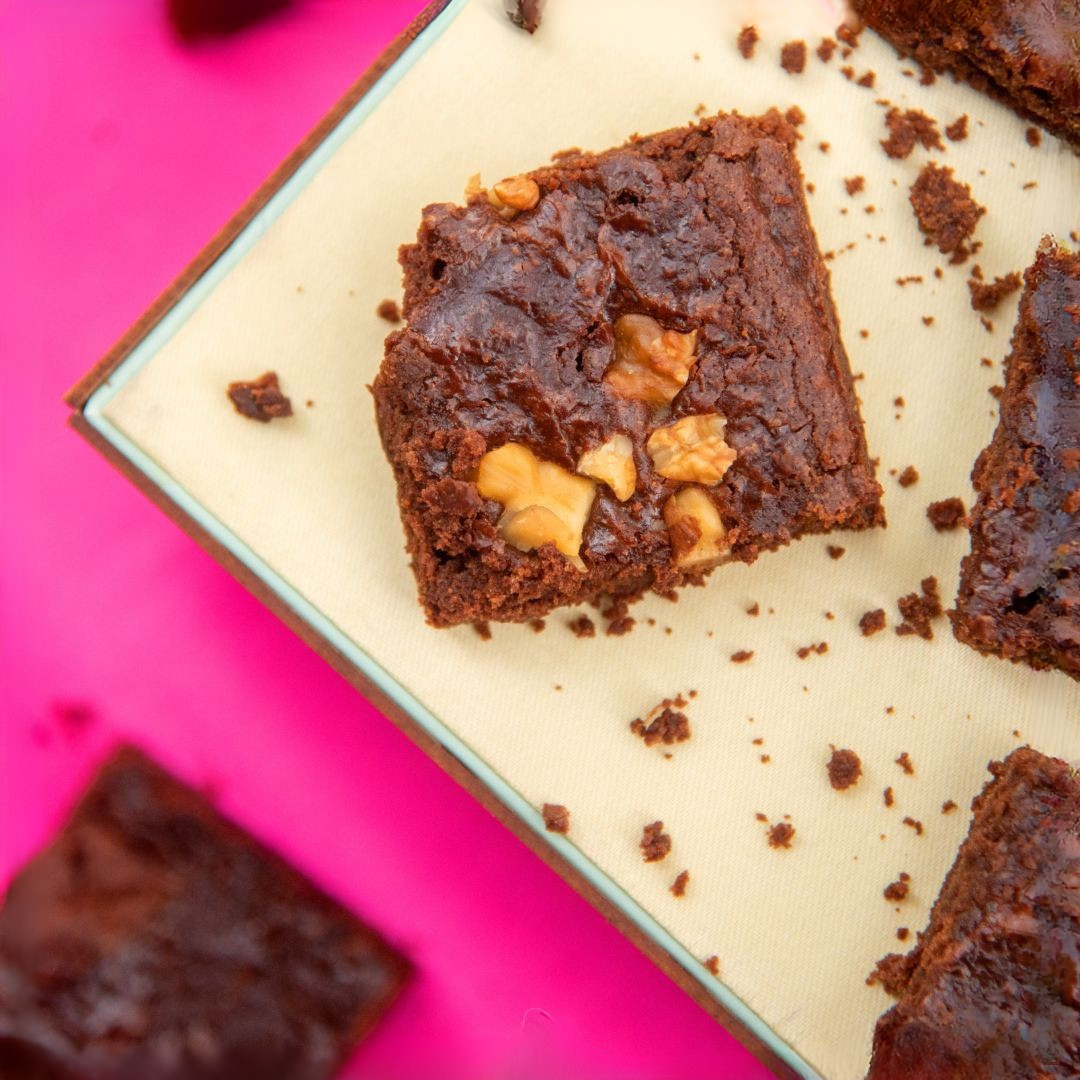 Freshly baked brownies with a glossy chocolate glaze, ready to be enjoyed.