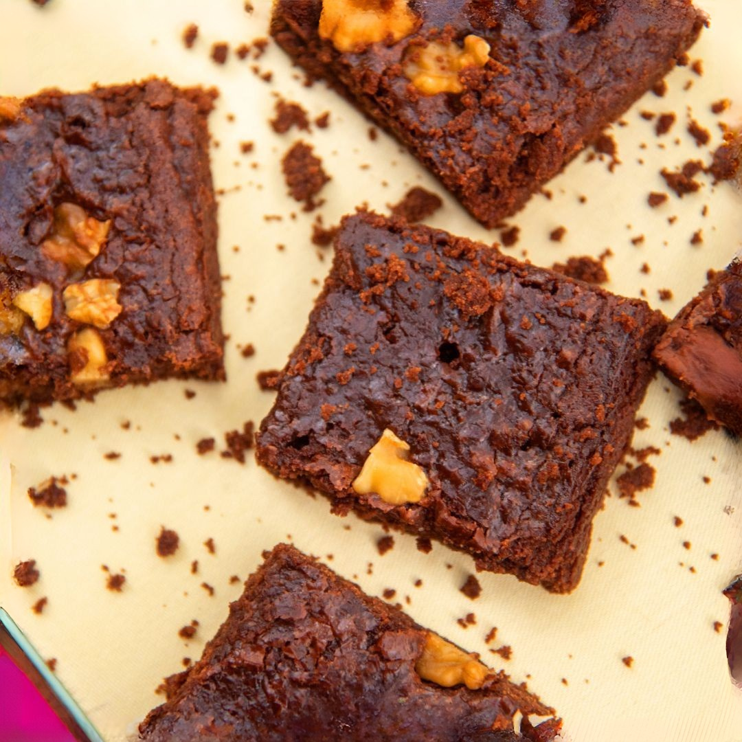 Freshly baked brownies with a glossy chocolate glaze, ready to be enjoyed.